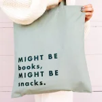 original_might-be-books-might-be-snacks-green-tote-bag.webp